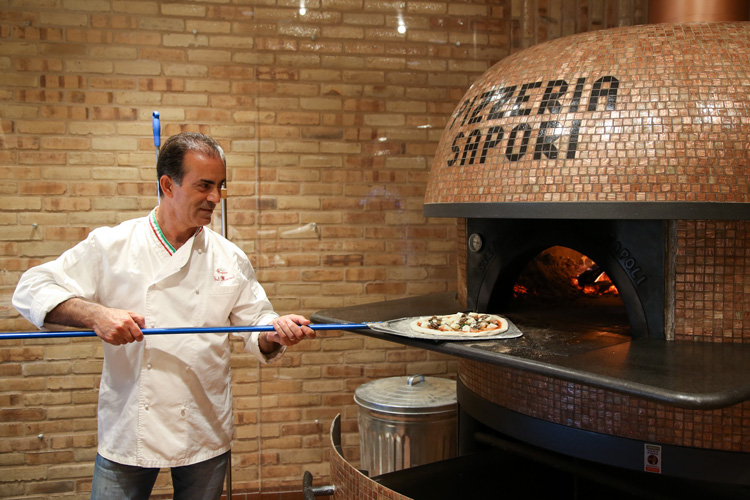 Pizzeria Sapori chef-owner Sal Maniaci meticulously prepares the dough before it’s fired in an imported oven. 