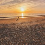 stress less with walks on the beach – credit Noah Sauve/shutterstock